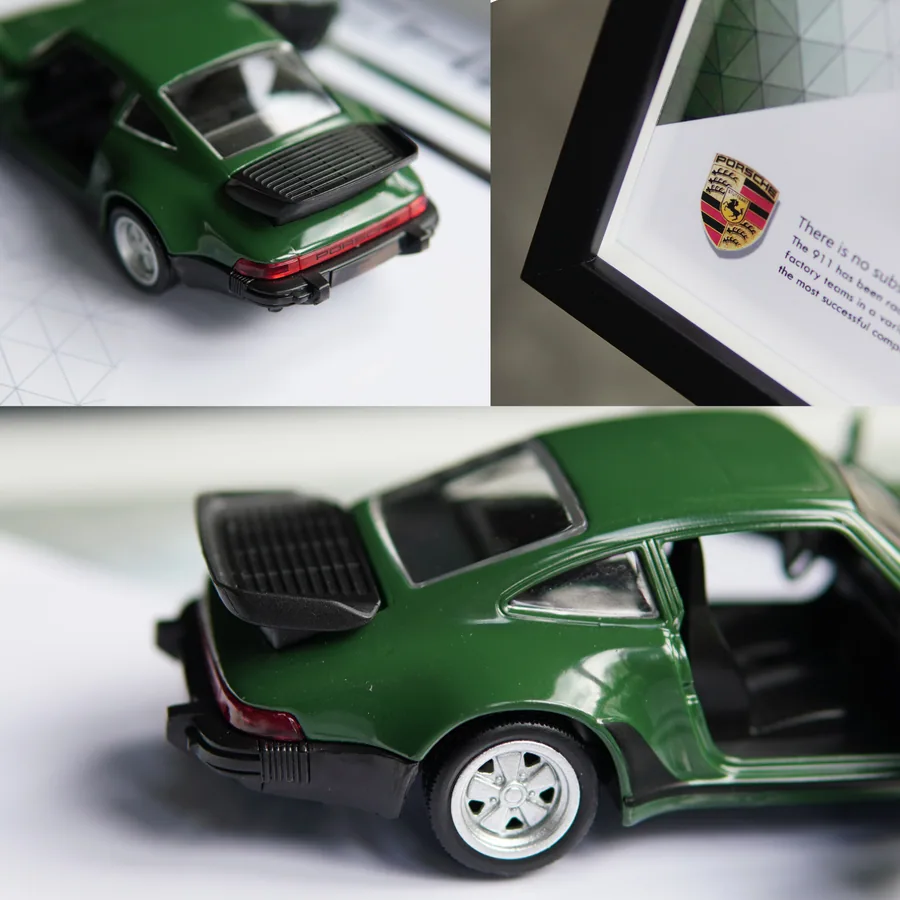 Close-up of a green Porsche 911 Turbo diecast model and black frame